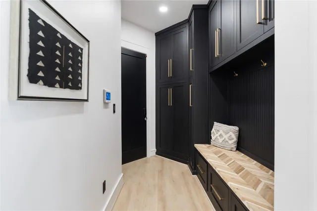 a bedroom with a bed and a painting on the wall