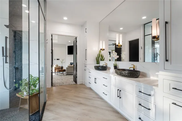 a large kitchen with stainless steel appliances a lot of counter top space and a view of living room