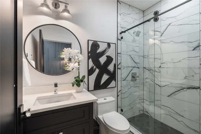 a bedroom with a large bed and two window