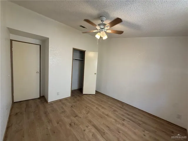 a view of an empty room and wooden floor