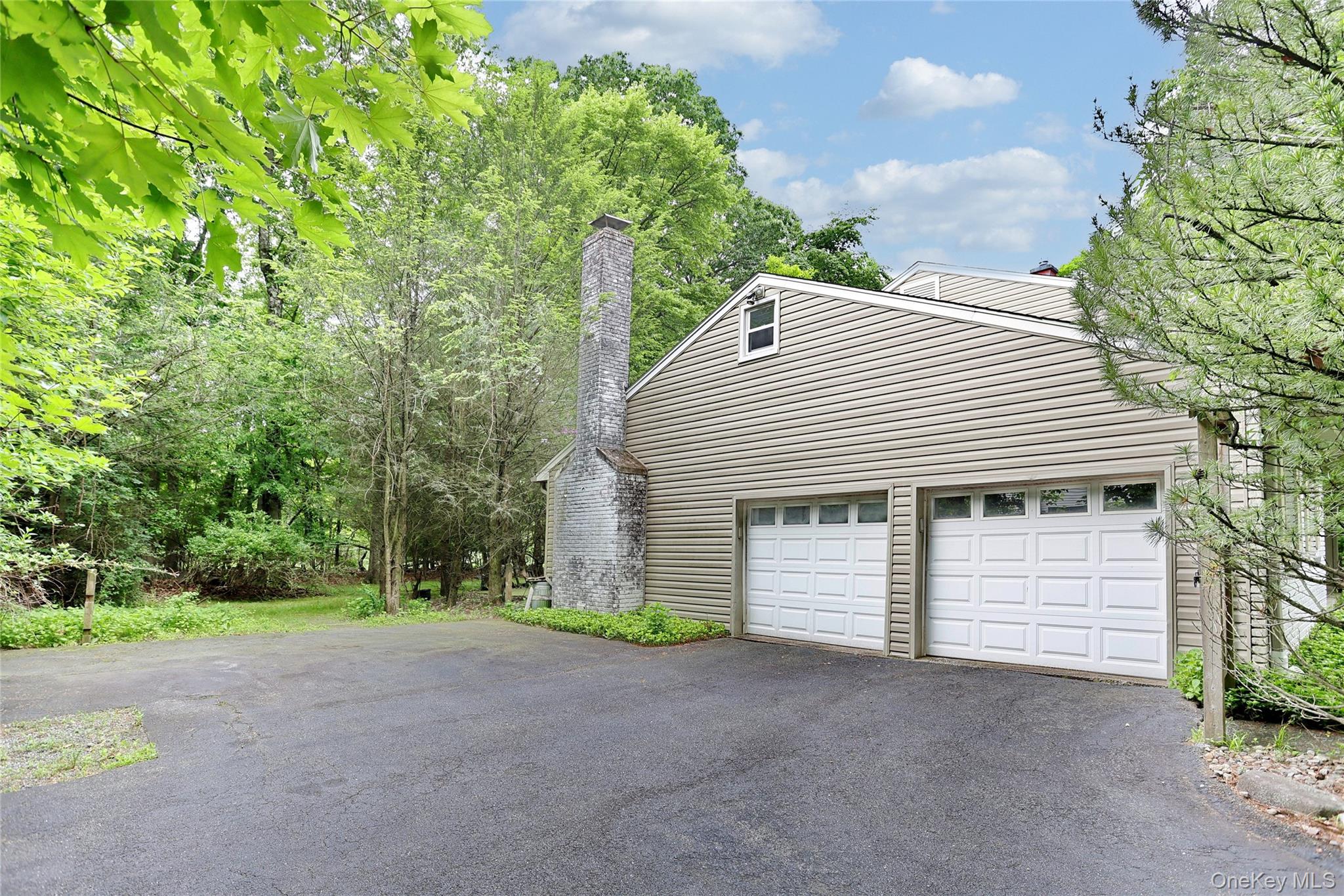 8 Swallow Avenue Spring Valley, NY 10977 - Photo 23 of 28 a view of a house with a yard and garage