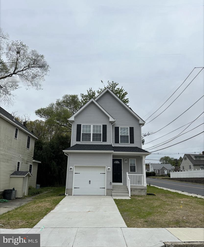 300 Saunders Avenue Bellmawr, NJ 08031 - Photo 1 of 1 a front view of a house with a yard and garage