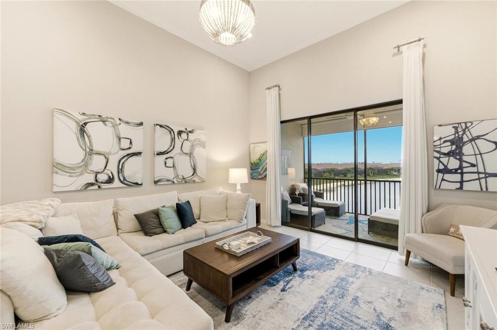 9365 Pocida Court, Unit 202 Naples, FL 34119 - Photo 13 of 40 a living room with furniture and a large window