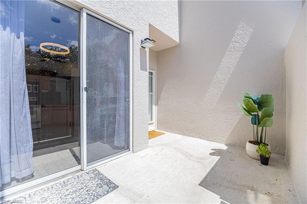 3735 Fieldstone Boulevard, Unit 9 Naples, FL 34109 - Photo 11 of 14 Property entrance featuring stucco siding