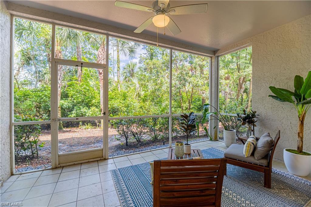 3735 Fieldstone Boulevard, Unit 9 Naples, FL 34109 - Photo 6 of 14 a living room with furniture and a potted plant