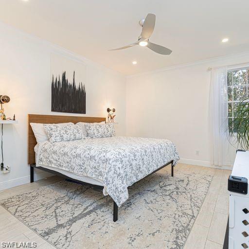 3735 Fieldstone Boulevard, Unit 9 Naples, FL 34109 - Photo 7 of 14 a bedroom with a bed and a potted plant on dresser