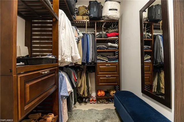 a view of walk in closet with clothes