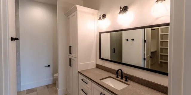 a bathroom with a sink and mirror