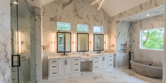 a bathroom with double vanity sinks a toilet a mirror and a tub