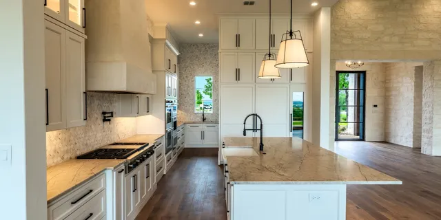 a kitchen with sink a stove and cabinets
