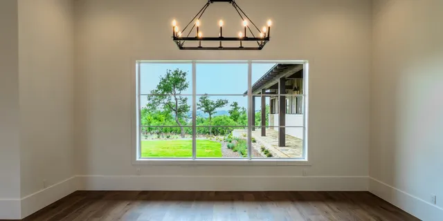 a view of wooden floor chandelier and entryway