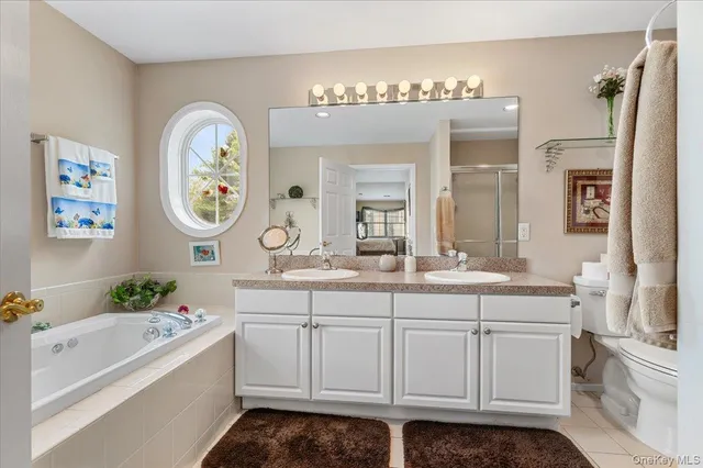 a spacious bathroom with a double vanity sink and a mirror