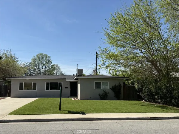 a view of a yard in front view of a house