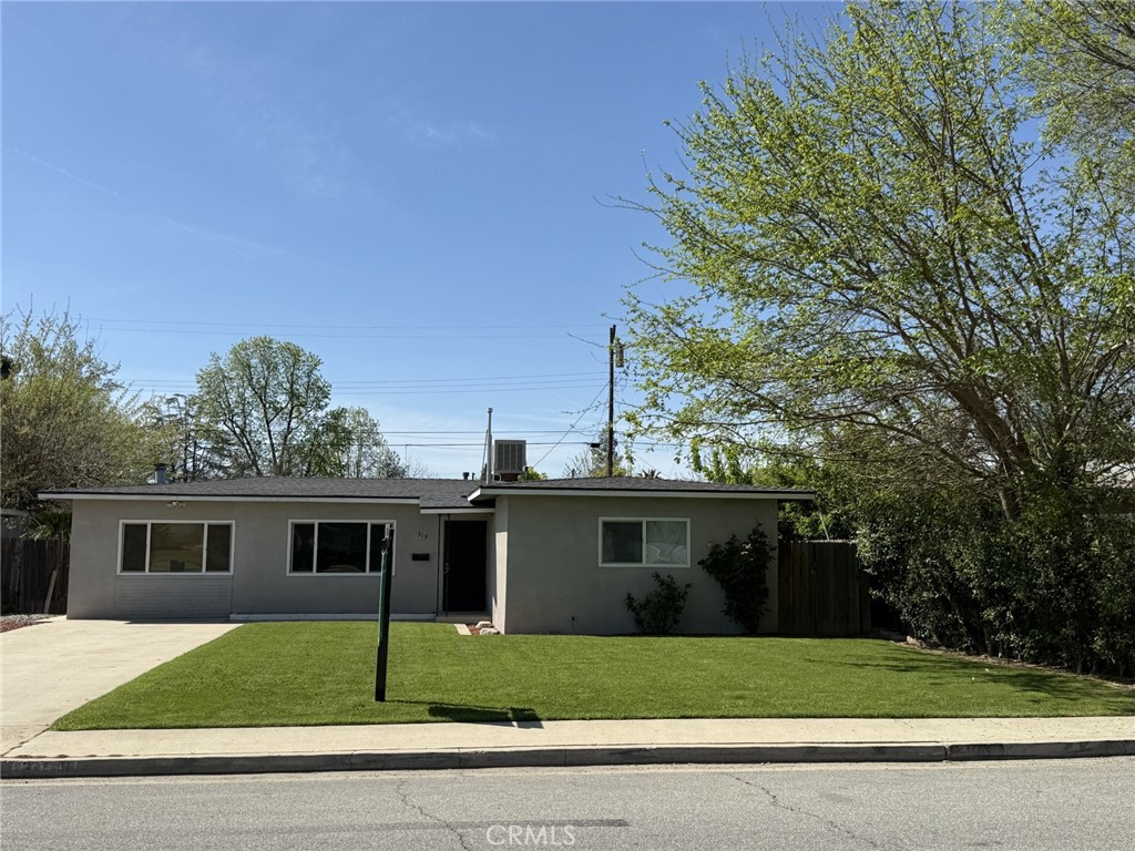 a view of a yard in front view of a house