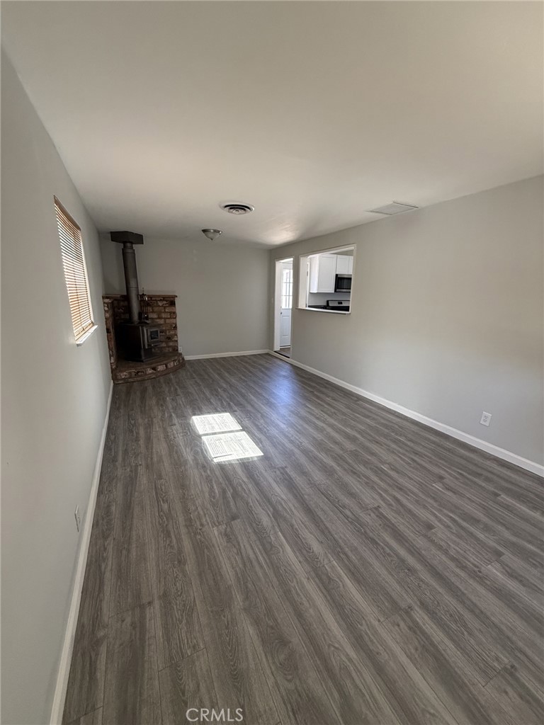 319 Elm Street Shafter, CA 93263 - Photo 11 of 14 wooden floor in an empty room with a window