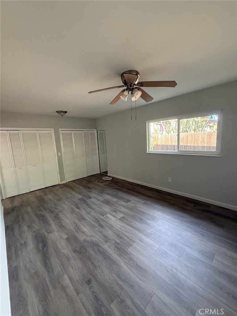 319 Elm Street Shafter, CA 93263 - Photo 14 of 14 an empty room with wooden floor and windows