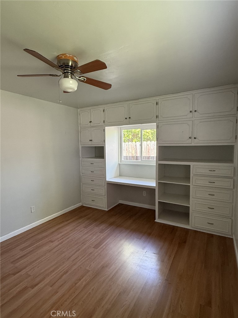 319 Elm Street Shafter, CA 93263 - Photo 2 of 14 wooden floor in an empty room with a window
