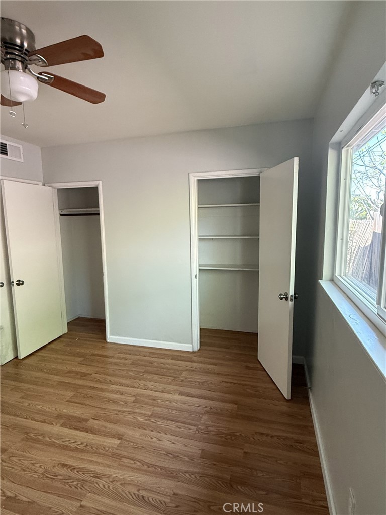 319 Elm Street Shafter, CA 93263 - Photo 3 of 14 a view of an empty room with a window and wooden floor