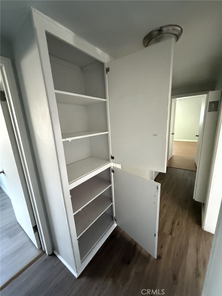 319 Elm Street Shafter, CA 93263 - Photo 5 of 14 a view of walk in closet with wooden floor and stairs