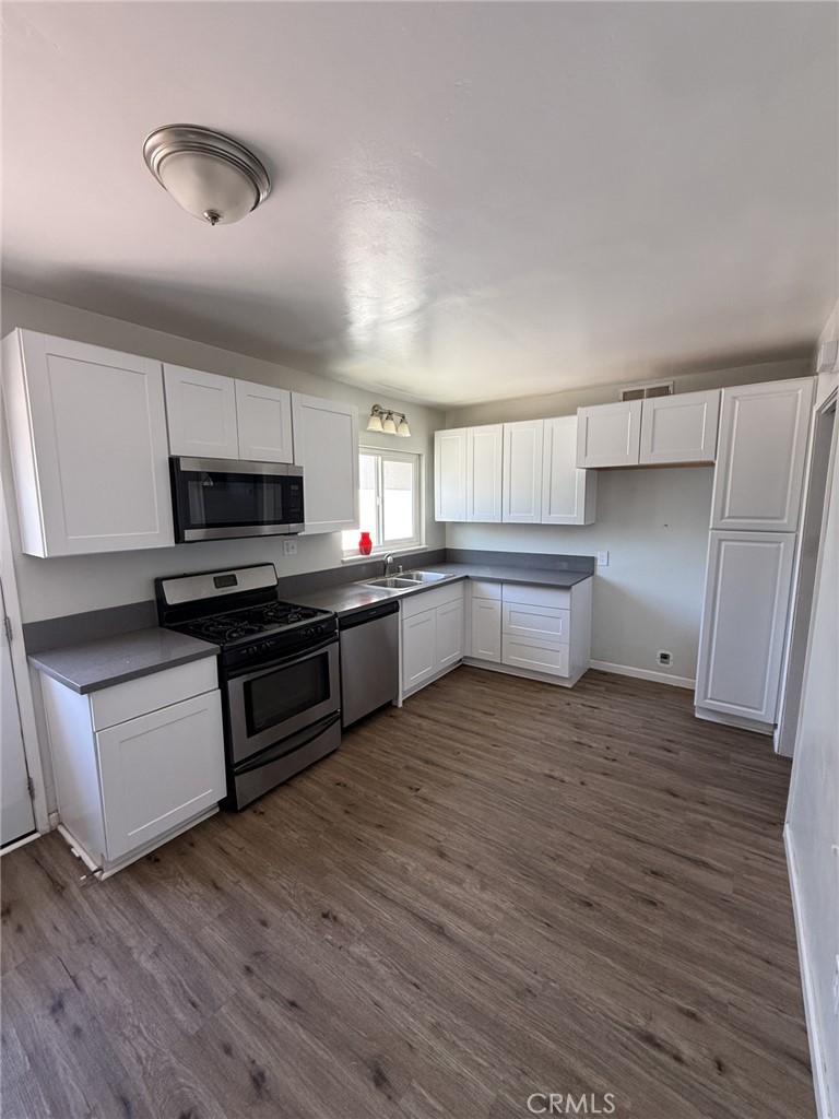 319 Elm Street Shafter, CA 93263 - Photo 6 of 14 a kitchen with stainless steel appliances a refrigerator and a stove top oven