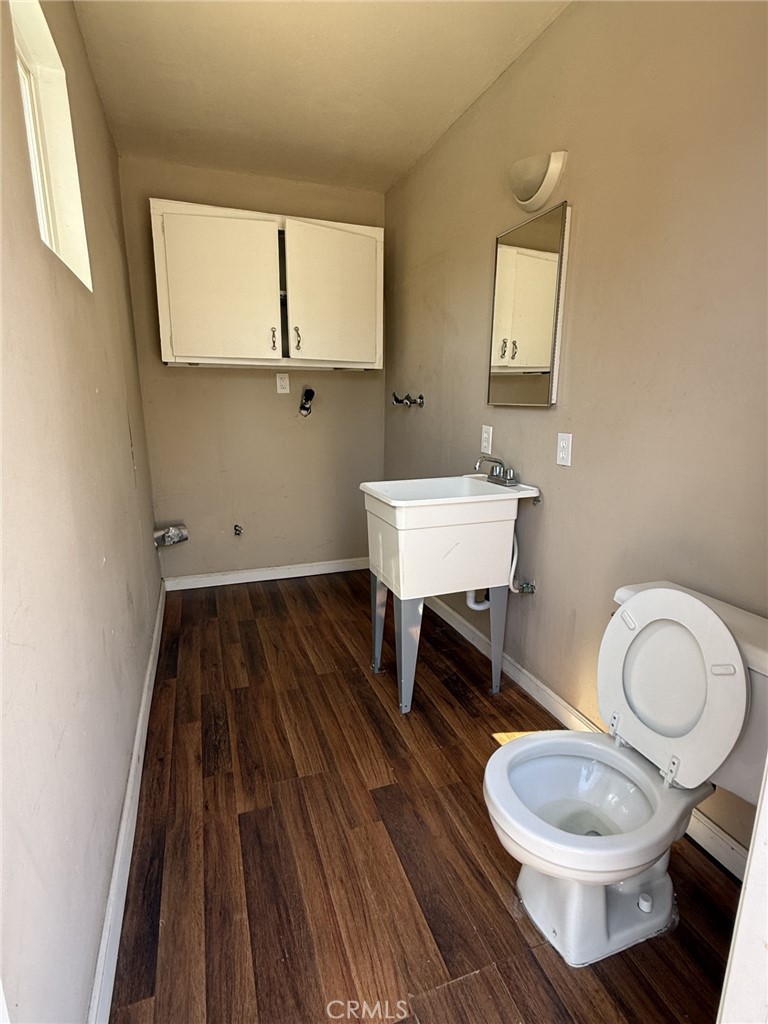 319 Elm Street Shafter, CA 93263 - Photo 9 of 14 a bathroom with a toilet a sink and mirror