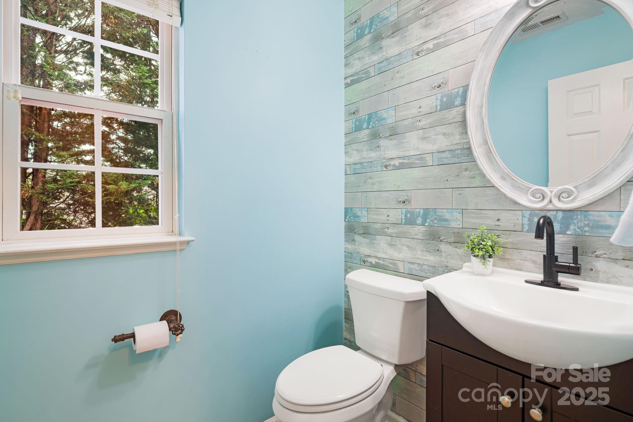 181 Farington Circle Fletcher, NC 28732 - Photo 12 of 33 a bathroom with a sink a toilet and a mirror