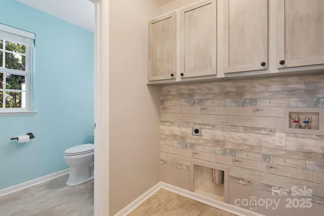 a bathroom with a granite countertop toilet and a sink