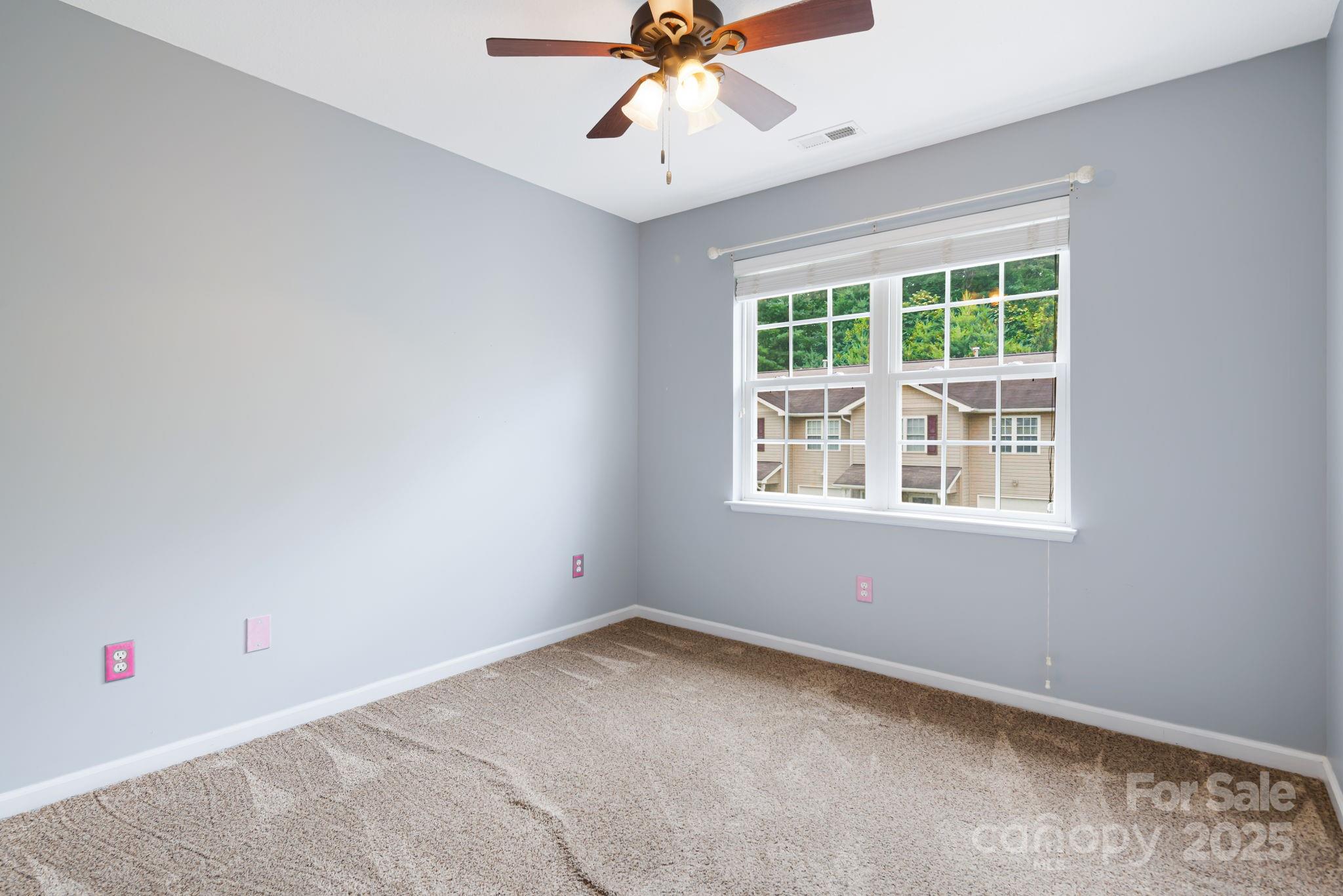 181 Farington Circle Fletcher, NC 28732 - Photo 17 of 33 an empty room with a window and a ceiling fan