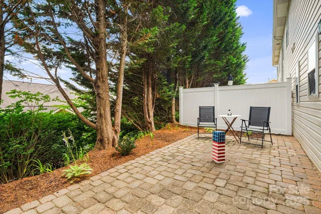 a view of a patio with a chairs and table in a patio