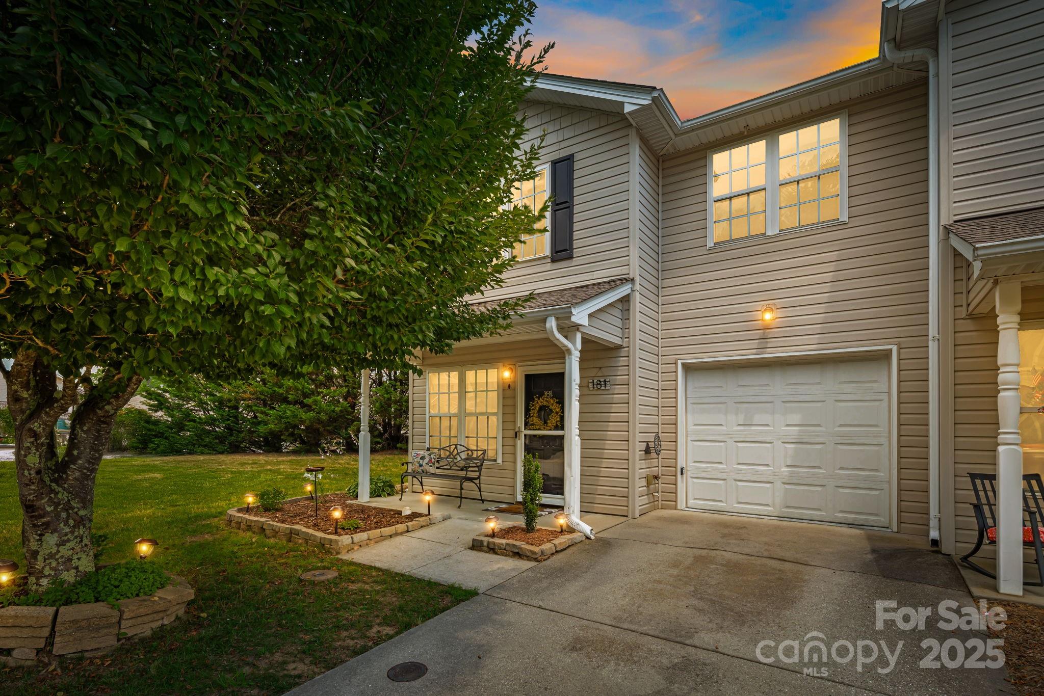 181 Farington Circle Fletcher, NC 28732 - Photo 30 of 33 a backyard of a house with outdoor seating and a garden