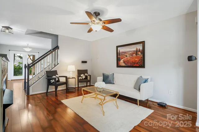 a living room with furniture and wooden floor