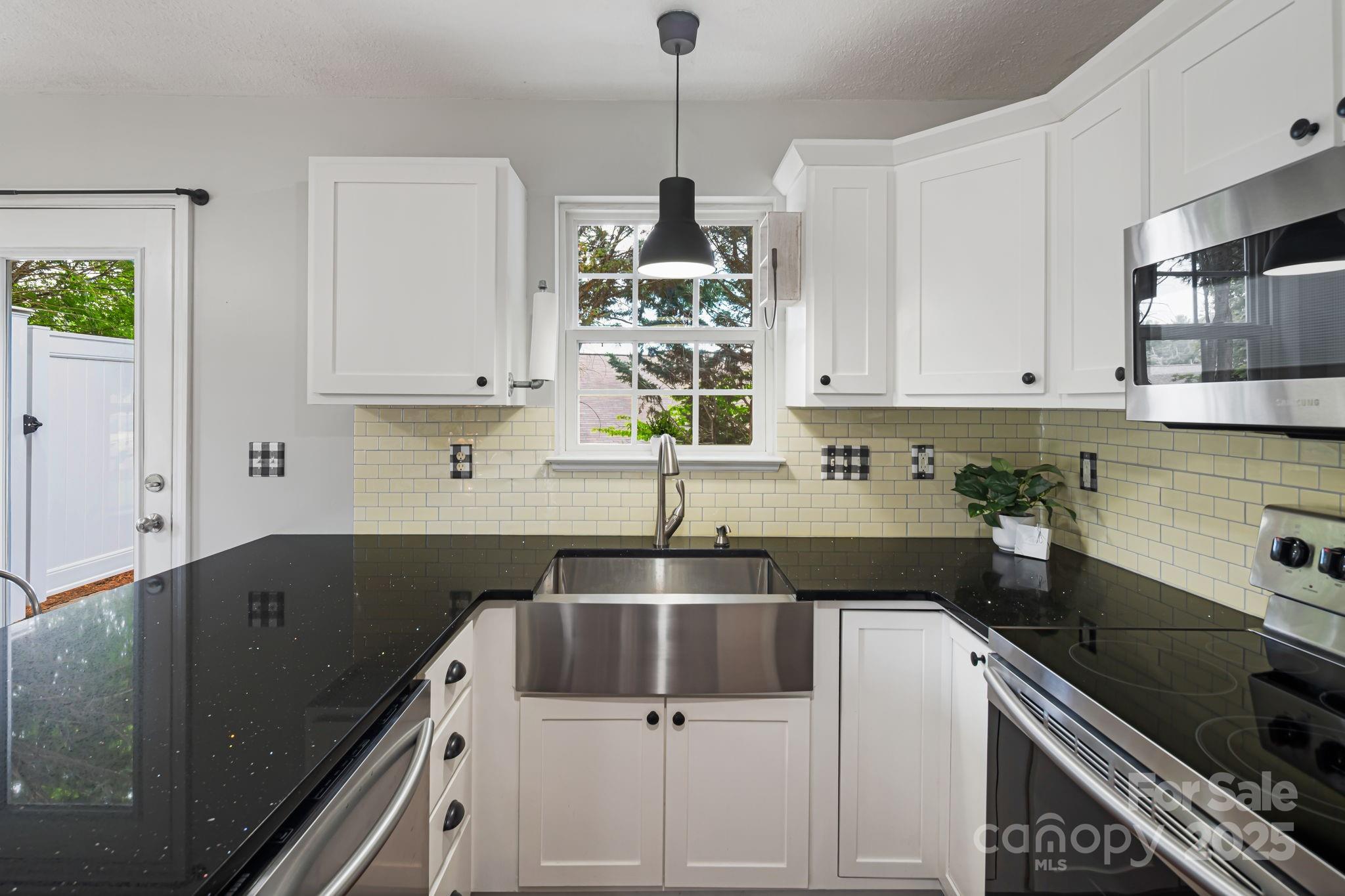 181 Farington Circle Fletcher, NC 28732 - Photo 10 of 33 a kitchen that has a sink and a stove in it