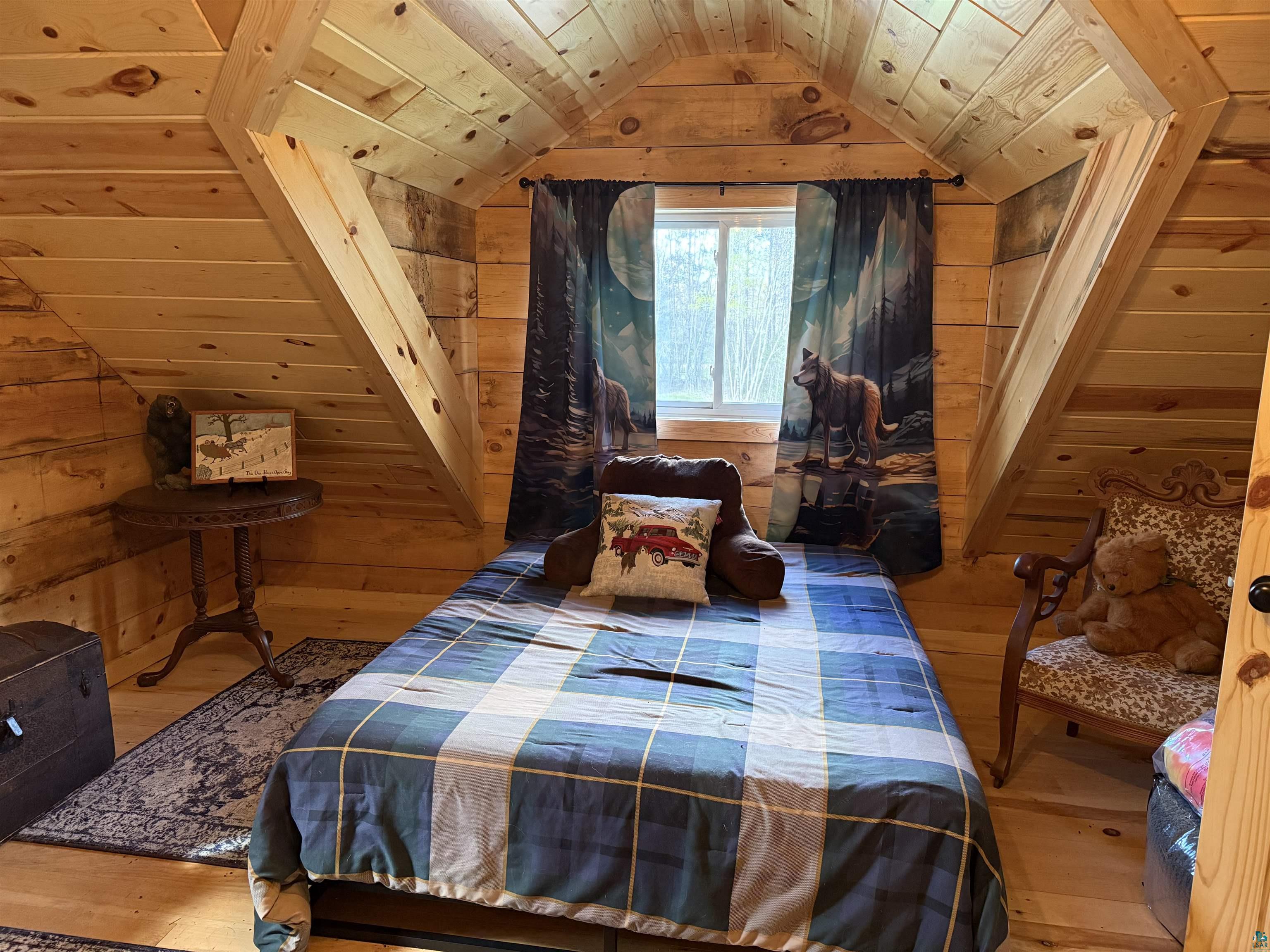 37590 Degerstrom Road Askov, MN 55704 - Photo 24 of 53 Attic room featuring natural wood plank walls and ceilings, a window with exterior visibility, and wood-finish flooring