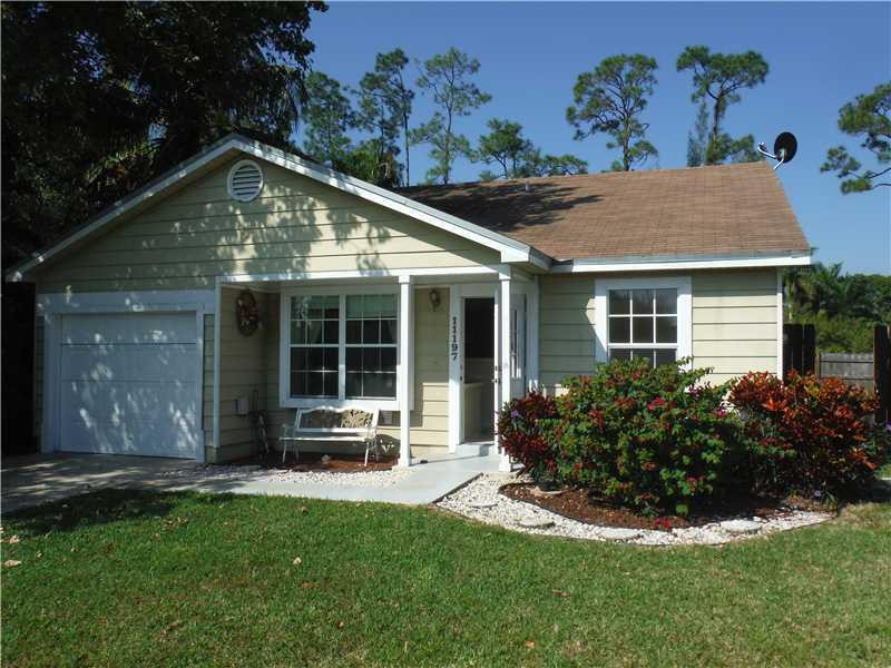 11197 Model Circle West Boca Raton, FL 33428 - Photo 1 of 23 a front view of a house with a yard