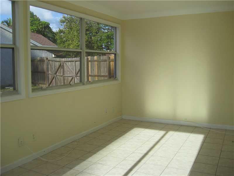 11197 Model Circle West Boca Raton, FL 33428 - Photo 11 of 23 an empty room with wooden floor and windows