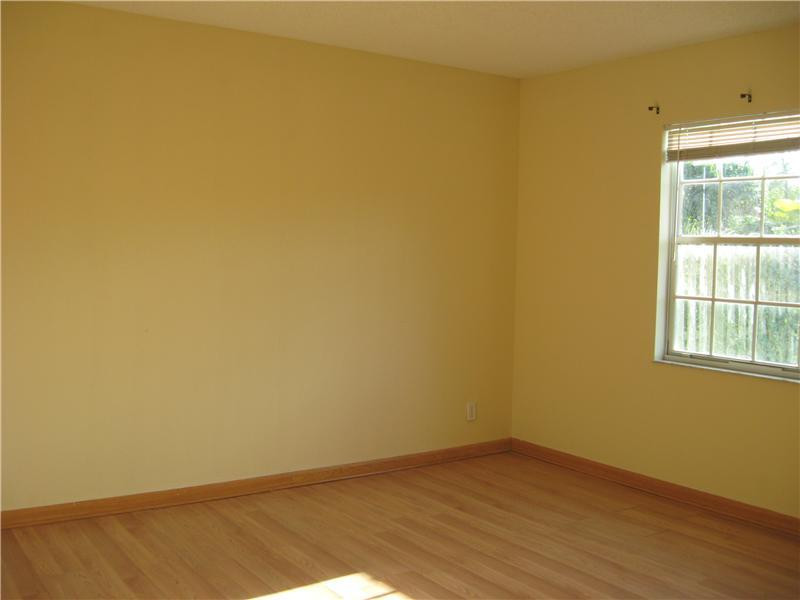 11197 Model Circle West Boca Raton, FL 33428 - Photo 16 of 23 a view of an empty room with wooden floor and a window