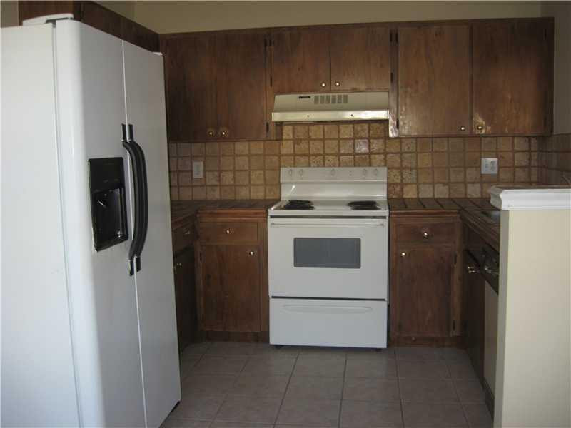 11197 Model Circle West Boca Raton, FL 33428 - Photo 6 of 23 a kitchen with a stove and a refrigerator