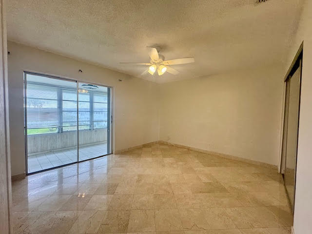 5520 North Ocean Boulevard, Unit 201 Ocean Ridge, FL 33435 - Photo 12 of 17 an empty room with windows and ceiling fan view