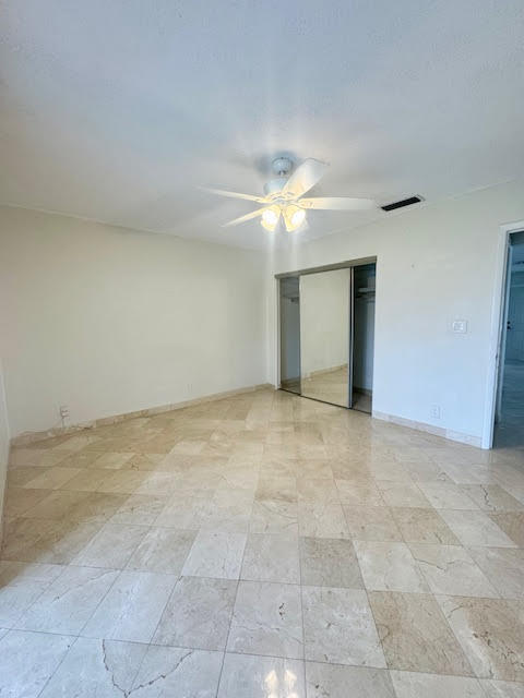 5520 North Ocean Boulevard, Unit 201 Ocean Ridge, FL 33435 - Photo 13 of 17 a view of an empty room with a ceiling fan