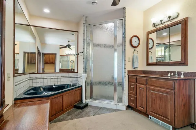 a spacious bathroom with a large tub sink and mirror