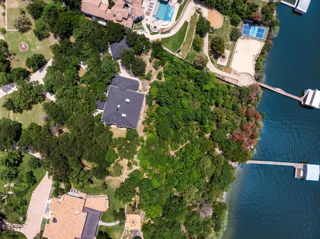 an aerial view of a house with a garden and lake view