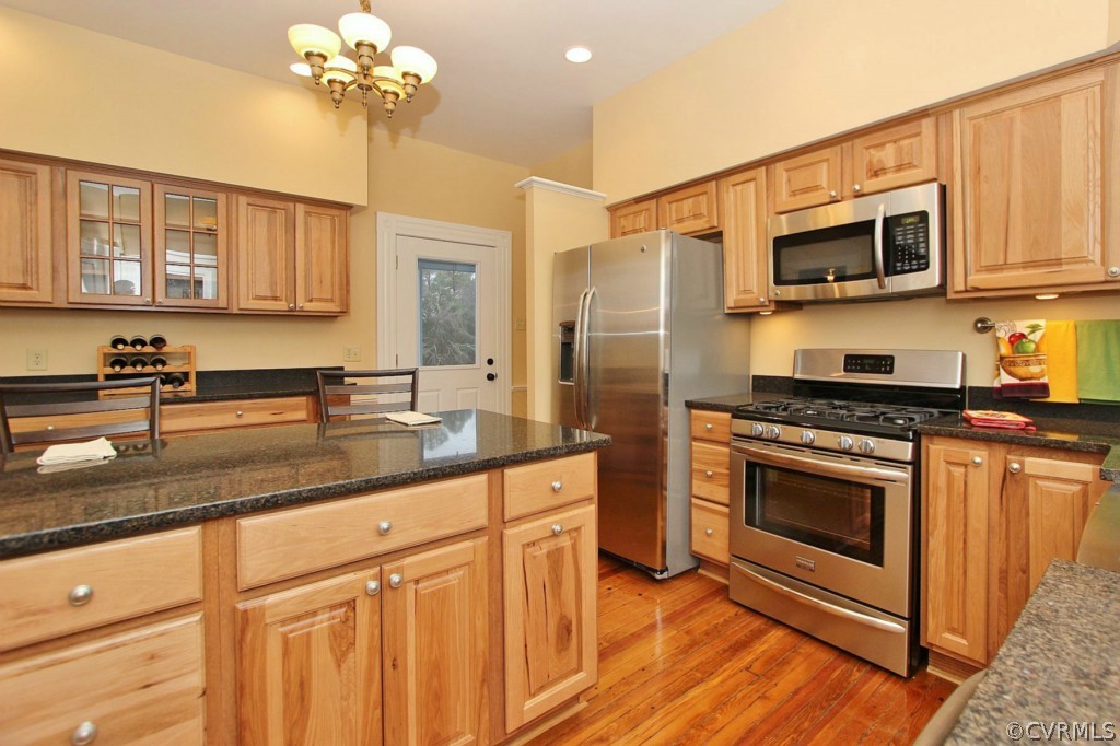 3005 Plank Road Kenbridge, VA 23944 - Photo 18 of 24 a kitchen with stainless steel appliances granite countertop a sink a stove a microwave and wooden floors