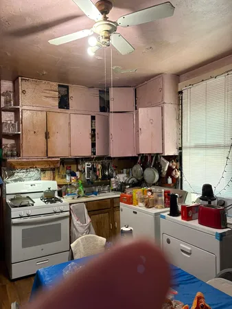 a kitchen with a stove cabinets and window