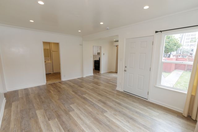 a kitchen with cabinets appliances a sink and a window