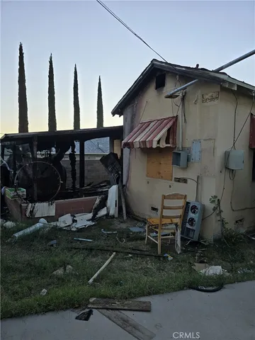 a view of backyard of house and chairs