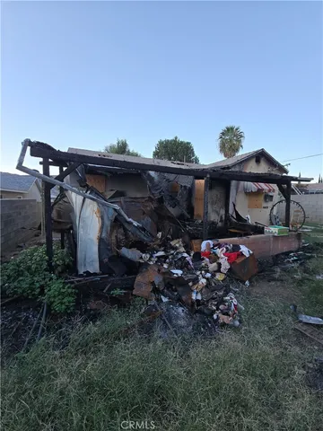 a view of a house with a backyard and a chair