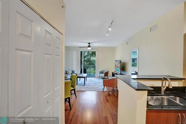 a kitchen with granite countertop a sink and a stove top oven