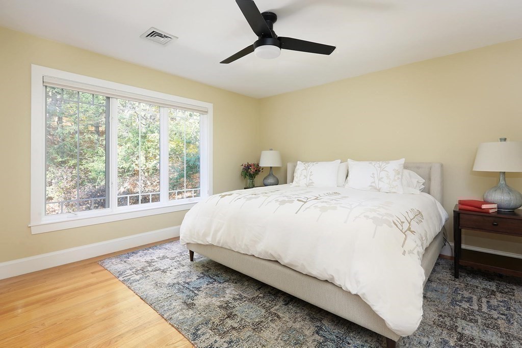 15 Laura Road Newton, MA 02468 - Photo 17 of 27 a large bed sitting in a bedroom next to a window