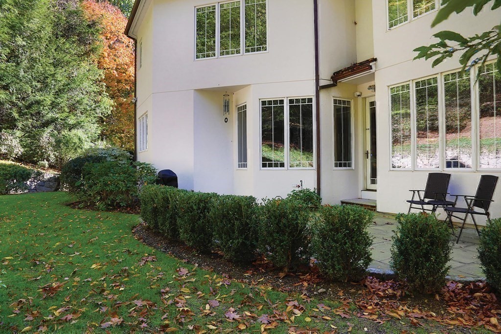 15 Laura Road Newton, MA 02468 - Photo 21 of 27 a view of a brick house with a yard and plants
