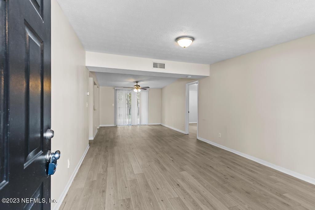7256 Merrill Road Jacksonville, FL 32277 - Photo 9 of 36 a view of a livingroom with wooden floor